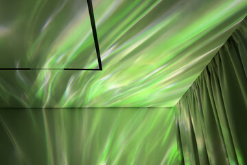 Green light reflections of projector dance across a textured ceiling and curtain, creating an ethereal ambiance in a modern interior space with a calming atmosphere