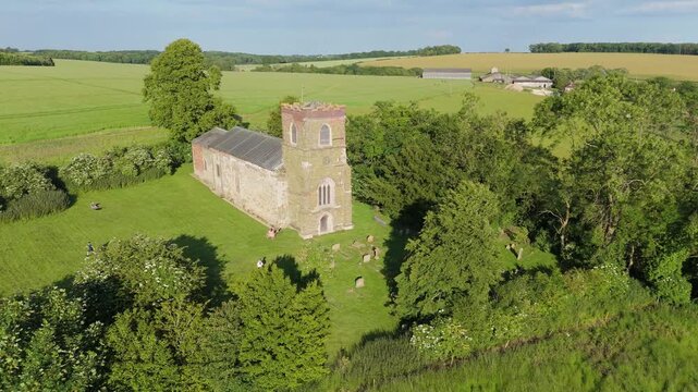 Quaint rural village church is a small, picturesque rural setting. St Mary's Church on the High Street of Burwell a peaceful atmosphere, beautiful natural landscapes, rolling hills. Rooftop views.