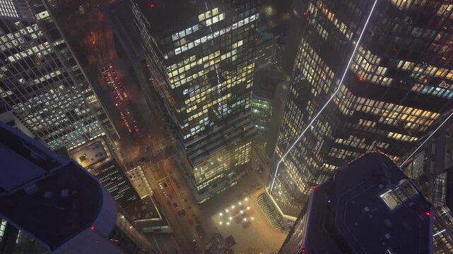 High angle aerial view of illuminated skyscrapers in financial district of Frankfurt, Germany. Corporate buildings and streets glow at night