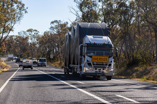 oversized load on truck carrying water tanks along Australian highway