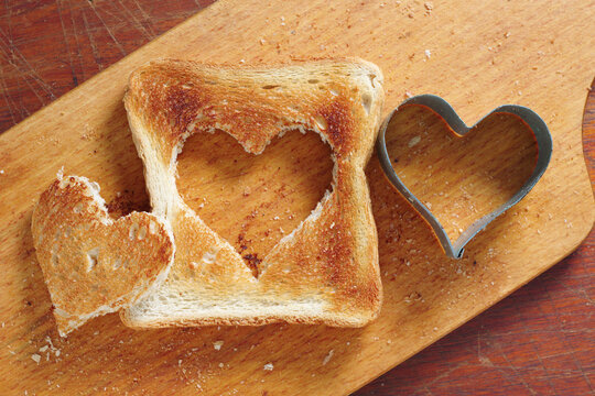Toasted bread with cut out heart-shaped slice