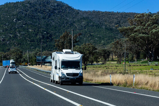 campervan travelling on country road in Australia in bright sunlight