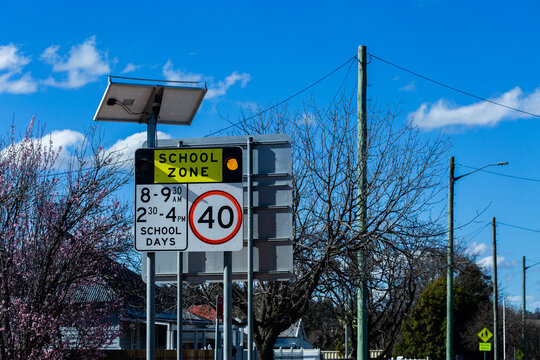 School zone 40 sign flashing lights in town
