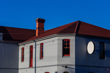 building with red roof and grey facade