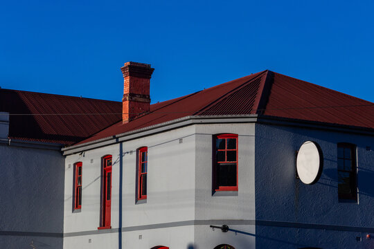 building with red roof and grey facade