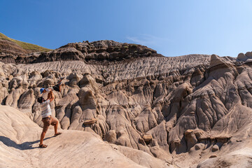 Father lifting his son in the hoodoos of drumheller, alberta, canada