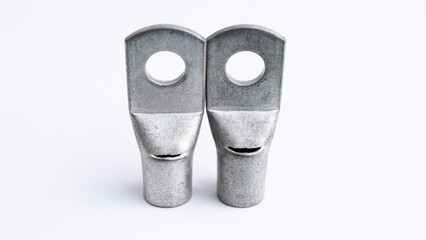 A close-up studio shot of two industrial silver aluminum or copper compression lugs, essential components for secure electrical terminations.