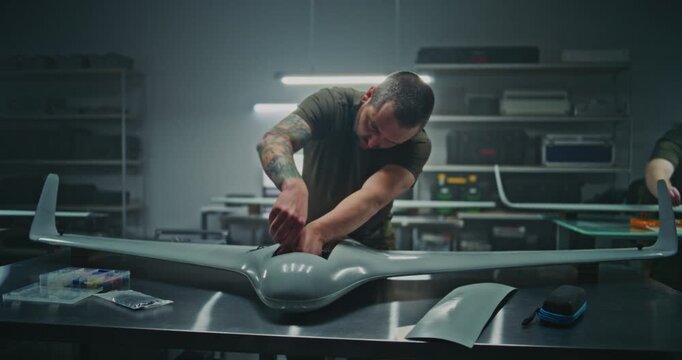 Efficient Industrial Design In Action, With Workers Building Sleek Unmanned Aerial Systems In Defense Factory. Concept Of Modern Manufacturing Process For Advanced Technological Products. Dolly Shot.