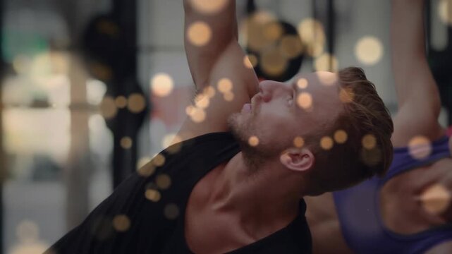 Fitness class acting on cue, doing side-stretch warmup, bokeh drifting, cam focusing male finishing