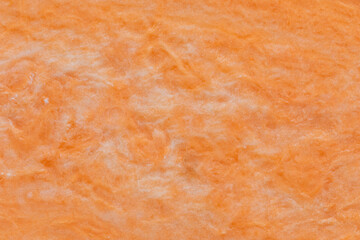 Close-up view of surface of halved sweet potato as a background texture. Orange wallpaper.
