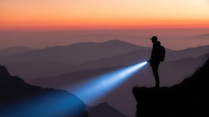 A solitary figure illuminated by a bright flashlight exploring the wilderness during a beautiful sunset over the majestic mountains