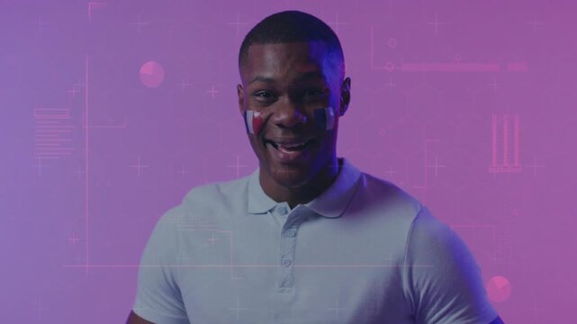 Zooming camera man lowering ball smiling revealing painted cheeks promoting match with HUD behind