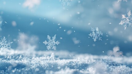 Naklejka premium Delicate snowflakes falling on a blue, snow-covered landscape, evoking winter's peaceful beauty and crisp atmosphere