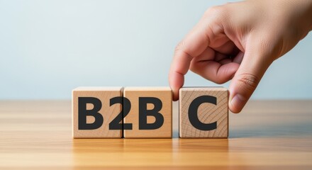 Naklejka premium Business Strategy: Hand Arranging Wooden Blocks with B2B and then C, Representing Business to Business and Customer