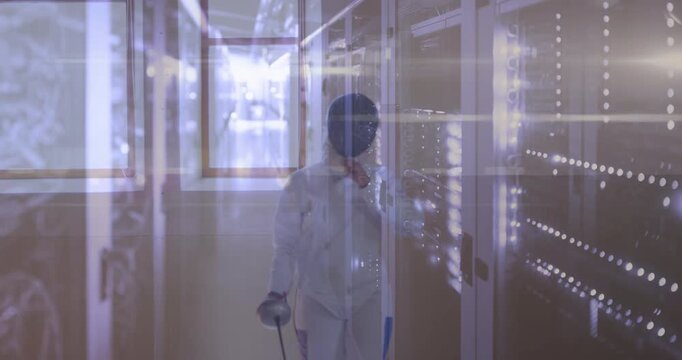 Female fencer walking sports glancing lockers checking gear removing mask LED dots reflecting mask
