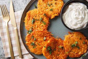 Fried sweet potato Hashbrown Patty closeup on the plate on the table. Horizontal top view from above