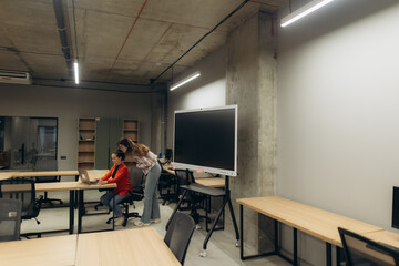 Two Coworkers Collaborating in a Modern Office Space With Technology