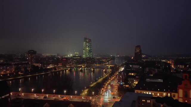 Aerial footage of the Frankfurt skyline at night, featuring new European Central Bank skyscrapers and Main river with city lights