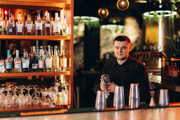 Bartender Preparing Drinks in a Cozy Atmospheric Bar Interior