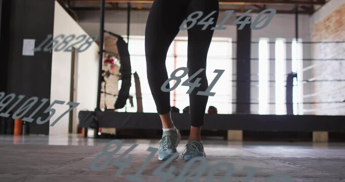 Woman starting two-foot hops then switching feet for cardio, numeric overlay obscuring shoes, feet
