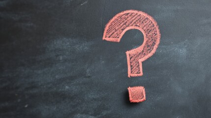Close-up of a blackboard with a red chalk drawing of a question mark on it. the question mark is drawn in a cursive font and is outlined in red.