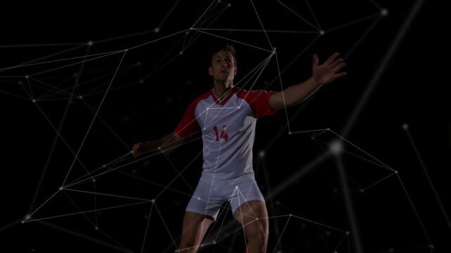 Male soccer player tracking incoming ball to intercept, leaping and striking as particles wrap