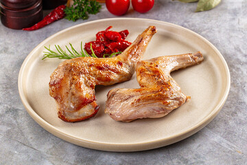 Roasted rabbit leg served rosemary