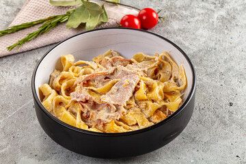 Italian pasta fettuccine with prosciutto