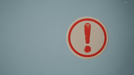 A bold red exclamation mark symbol enclosed within a red oval border on a plain light blue background signifying a warning or important alert