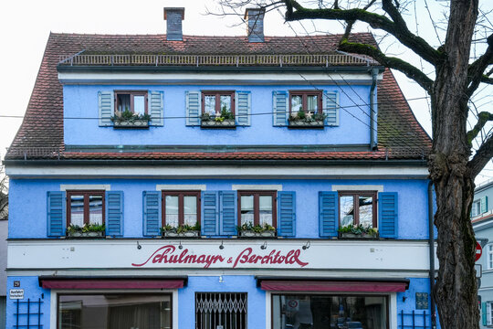 Blue residential and commercial building on Augsburger Stra&szlig;e in Dachau, Upper Bavaria, which houses the Schulmayr and Berchtold electrical company.