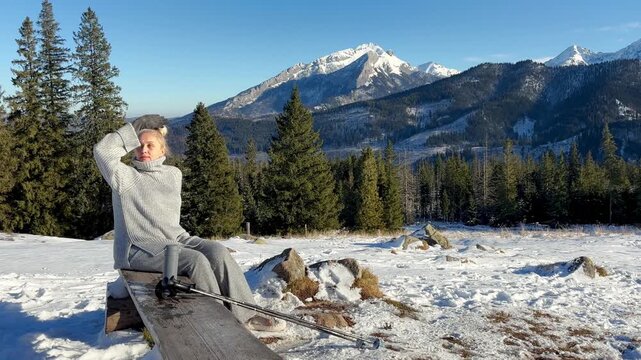 Woman with thermos on snowy mountains background