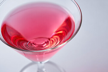 Close-up of a vibrant pink cocktail in a martini glass