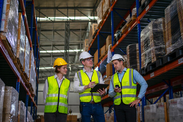 Blue collar workers are working at warehouse.