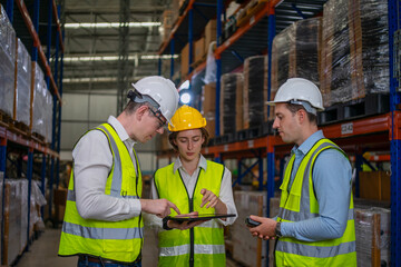 Blue collar workers are working at warehouse.