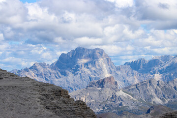 Fototapeta premium Aerial Dolomites landscape: jagged alpine peaks under heavy rain clouds, Italy’s mountain drama revealed