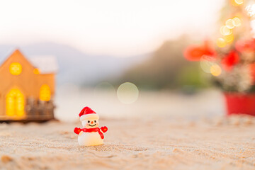 Santa Claus Doll Cute and Christmas Tree House Relaxing on the Beach. Merry Christmas Holiday. Bright Background. Patong Beach, Phuket, Thailand.