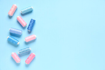 Thread spools on blue background