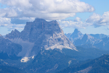 Dolomites Italy aerial shot: Sorapis Peak rising through stormy skies and drifting rain clouds