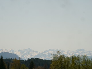 Mountain range is visible in the distance with a clear blue sky