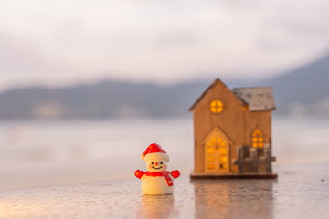 Merry Christmas word in wooden on the beach of tidewater green tone background, wide banner, Christmas banner, happy concept, copy space, soft focus Sky in the morning, Patong Beach, Phuket Thailand