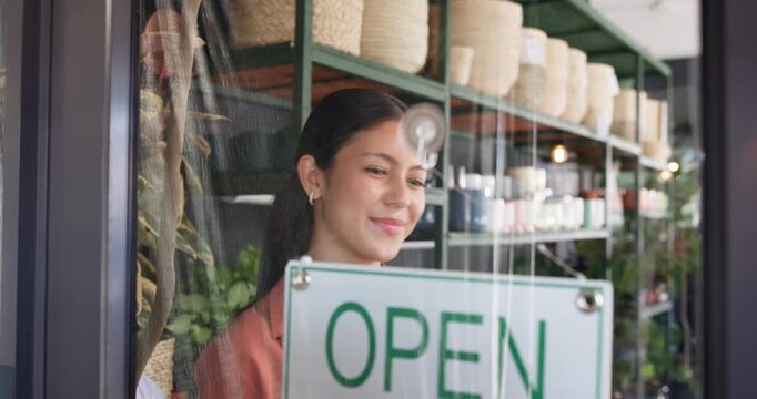 Florist, woman and happy with open sign at window for public notice, start day or welcome message. Storefront, employee and smile with signage at plant shop for sustainable startup and information