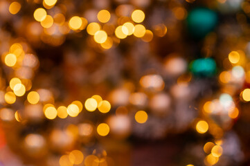 Colorful Christmas ornaments with soft sparkling holiday bokeh on festive decorated evergreen tree