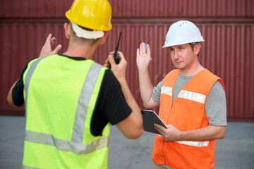 Worker discussing while working in container yard