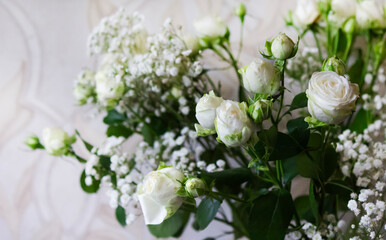 A beautifully arranged bouquet. A perfect combination of white roses on a beige background