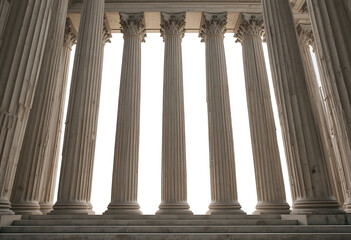 Large stone columns with ornate capitals on a building facade architecture
