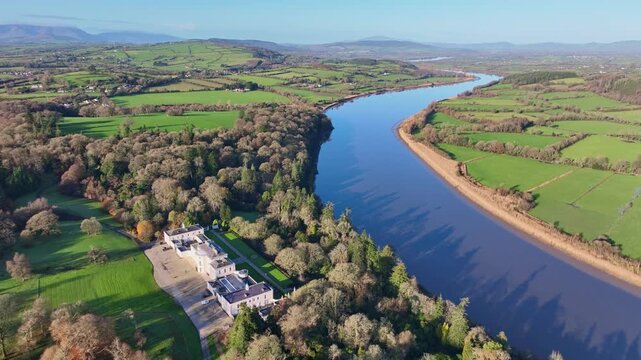 Aerial fly over Mount Congreve Gardens with stunning view of winding Suir River Waterford Ireland in winter