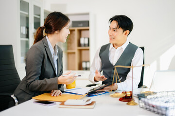 Professional business team discussing documents in a modern office. Collaboration, consulting, and teamwork concept