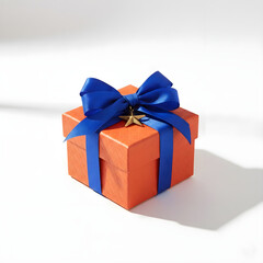 Obraz premium Square Orange Gift Box with Blue Satin Ribbon and Gold Star Charm, Ribbed Texture on White Background, Festive Holiday or Birthday Present Concept