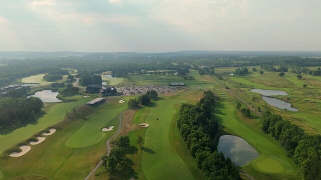 Wide drone shot of TPC Toronto at Osprey Valley, highlighting fairways, bunkers, ponds, clubhouse activity, and the expansive tournament-ready course layout.