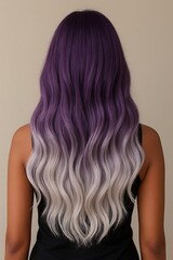 Fototapeta premium A back view of a person with long, wavy hair that has a beautiful purple and white ombre color transition.